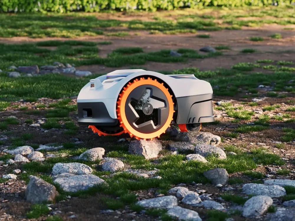 Praca na wyboistym terenie z kamieniami Robot koszący Segway Navimow i210 AWD – koszenie na nierównym terenie z kamieniami, napęd 3AWD i system TCS